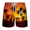 Men's beach swim shorts with a tropical coconut tree print against an orange sunset background
