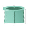 A light mint green foldable baby potty training seat with a circular opening and side panels.