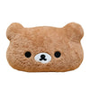 A brown Rilakkuma soft plush hand rest pillow with black eyes and a white nose.