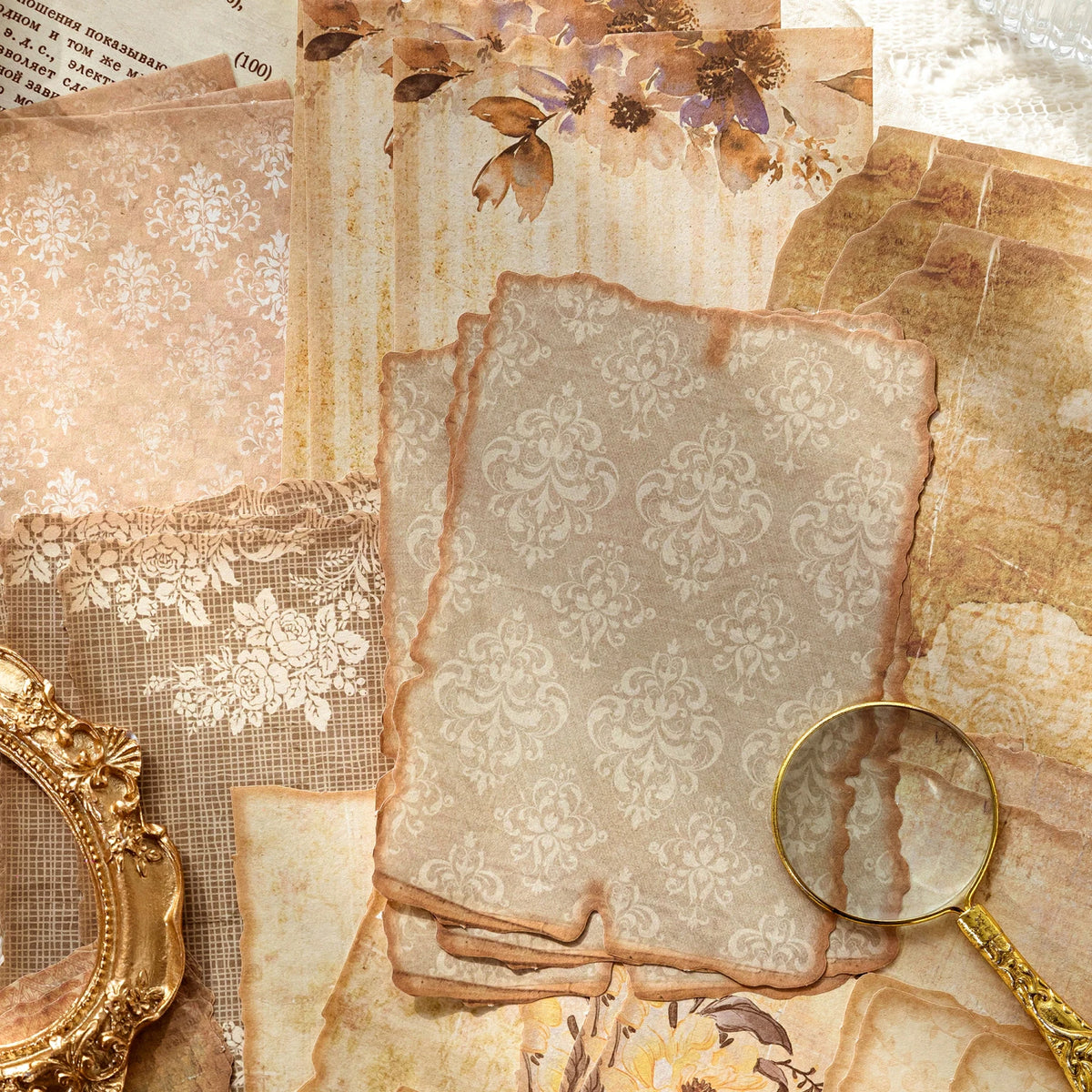 A collection of vintage paper sheets and textured materials used for journaling and scrapbooking.