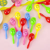 A collection of colorful mini maracas shaker toys in various bright colors like pink, yellow, green, and red.