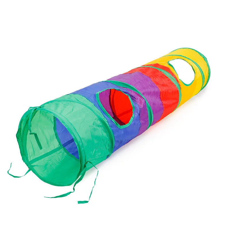 A colorful, foldable S-shaped cat tunnel with hanging ball toys in green, purple, red, and yellow.