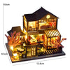A detailed wooden mini seaside villa dollhouse kit featuring furniture and an illuminated facade.