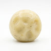 A round, pale yellow mashed potato squeeze toy stress reliever with visible texture.