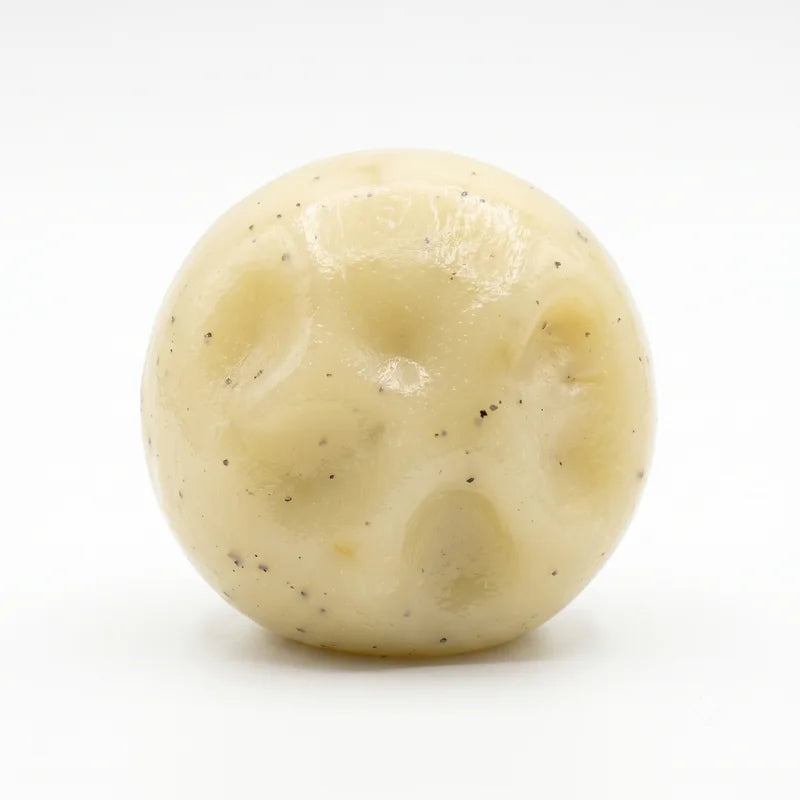 A round, pale yellow mashed potato squeeze toy stress reliever with visible texture.