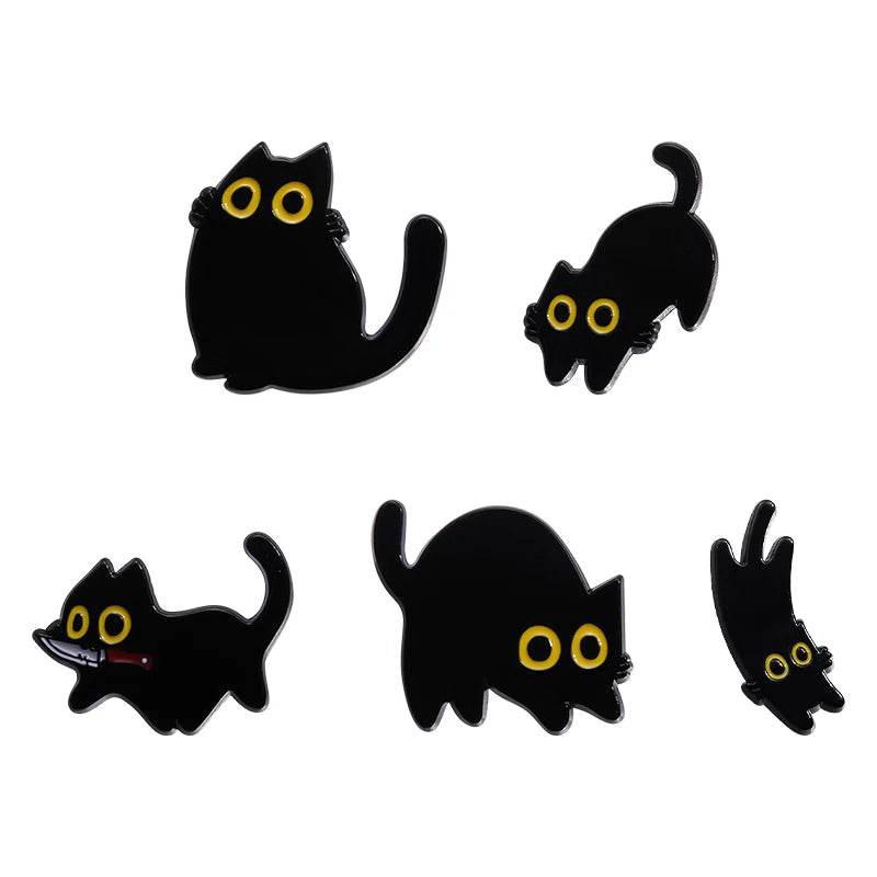 A set of four black cat enamel pins with glowing yellow eyes.