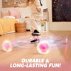A child is playing with a glowing, bouncing ball that emits light trails on a wooden floor.