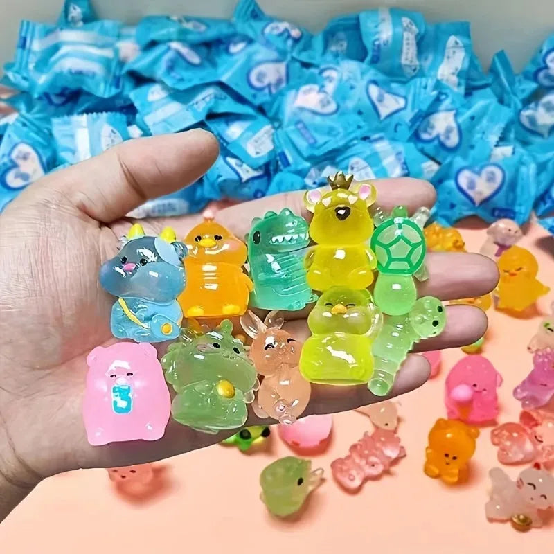 A hand holds a collection of glow-in-the-dark mini animal figures in various colors and shapes.