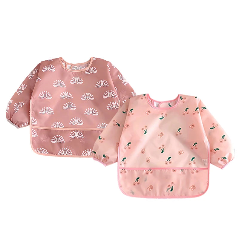 Pink full-sleeve waterproof baby bib with a cute rainbow and floral cartoon design