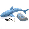 A blue remote control shark toy with light and water spray alongside its accessories.
