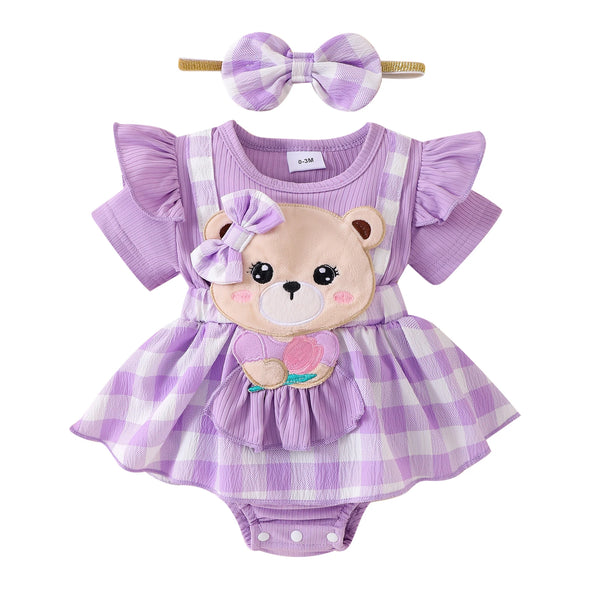A purple plaid romper dress for a baby girl featuring a bear appliqué and a bow accessory.