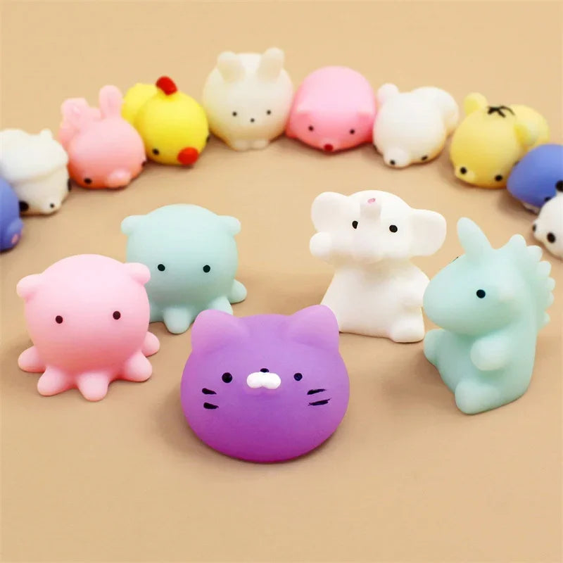 A collection of colorful, squishy mochi animal stress relief toys in various pastel colors arranged on a light background.