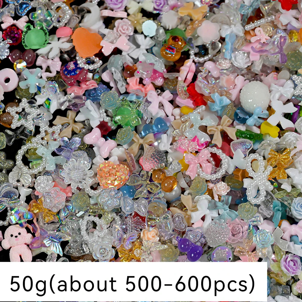 A close-up view of a large quantity of multicolor resin nail charms and embellishments.
