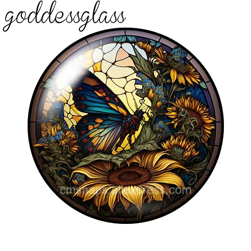 A round glass cabochon featuring a detailed floral design with yellow, orange, and blue hues.