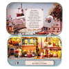 A miniature dollhouse theater kit featuring Parisian scenes and furniture.