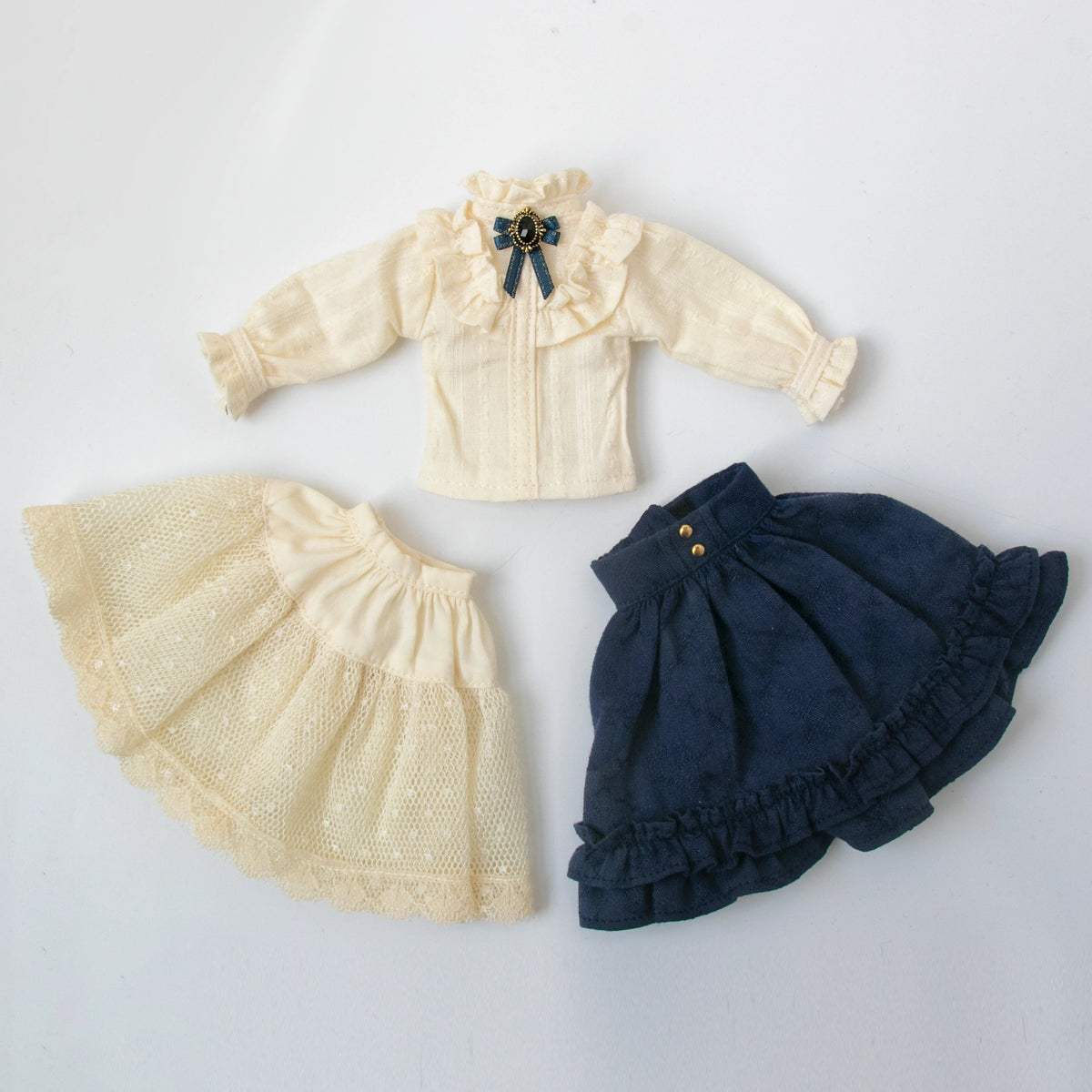 Vintage lace maid dress set for dolls featuring a cream blouse and matching skirt