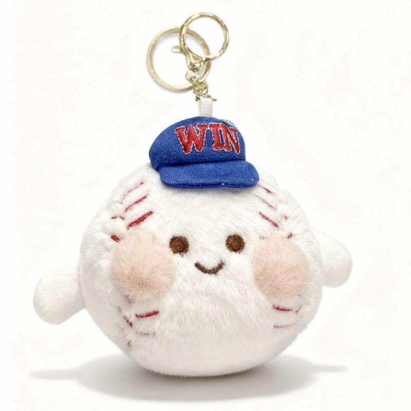 A white plush ball with pink cheeks and a blue baseball cap featuring the letters WIN, attached to a metal keychain.