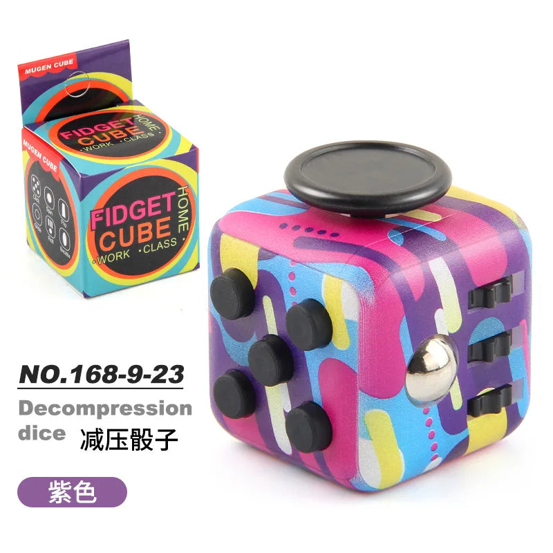 A purple and yellow fidget cube is shown next to its packaging, featuring silent and clicking buttons.