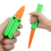 A hand holds an orange plastic butterfly knife fidget toy with green handles and a pointed tip.