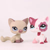 A light beige shorthair cat bobble head figurine with pink accents and sparkly purple markings.