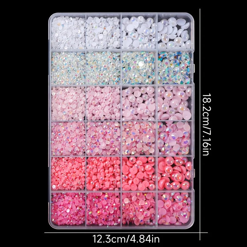 A tray of pink and white resin rhinestones and pearls for DIY crafts, arranged in various colors and sizes.
