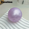 A smooth, translucent lavender silicone fidget ball resting on a white ribbed surface.