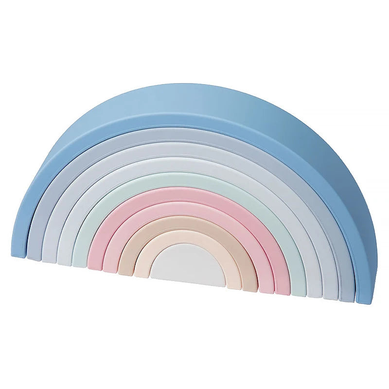 A rainbow arch made of soft silicone building blocks in pastel colors including blue, purple, pink, and white.