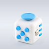 A white fidget cube with a blue rotating joystick and magnetic buttons.
