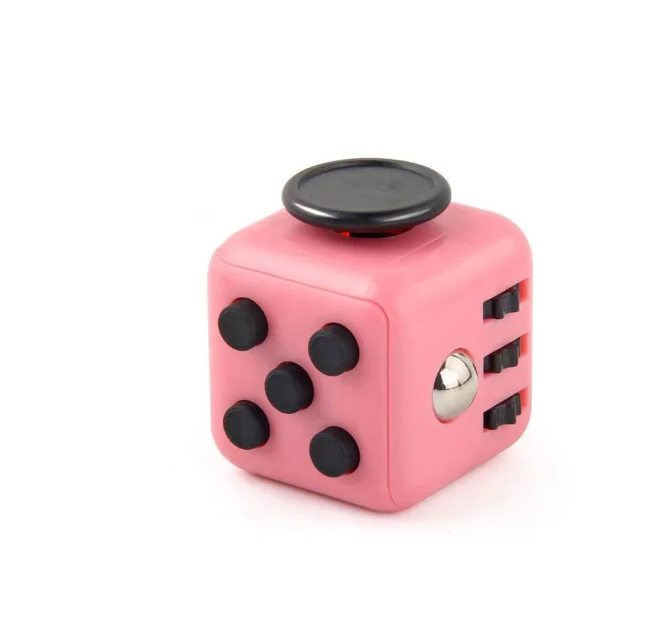A pink fidget cube with a rotating joystick and magnetic buttons.