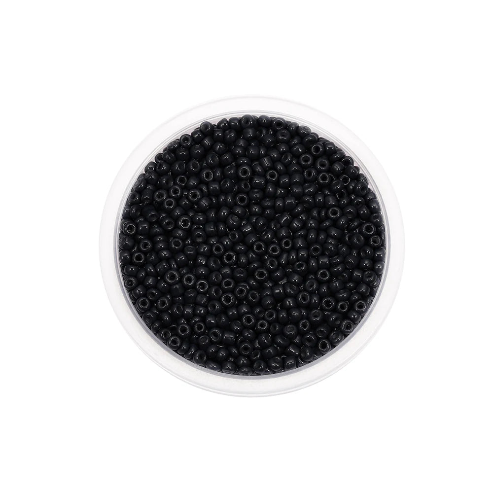 A clear container filled with black round glass seed beads for jewelry making