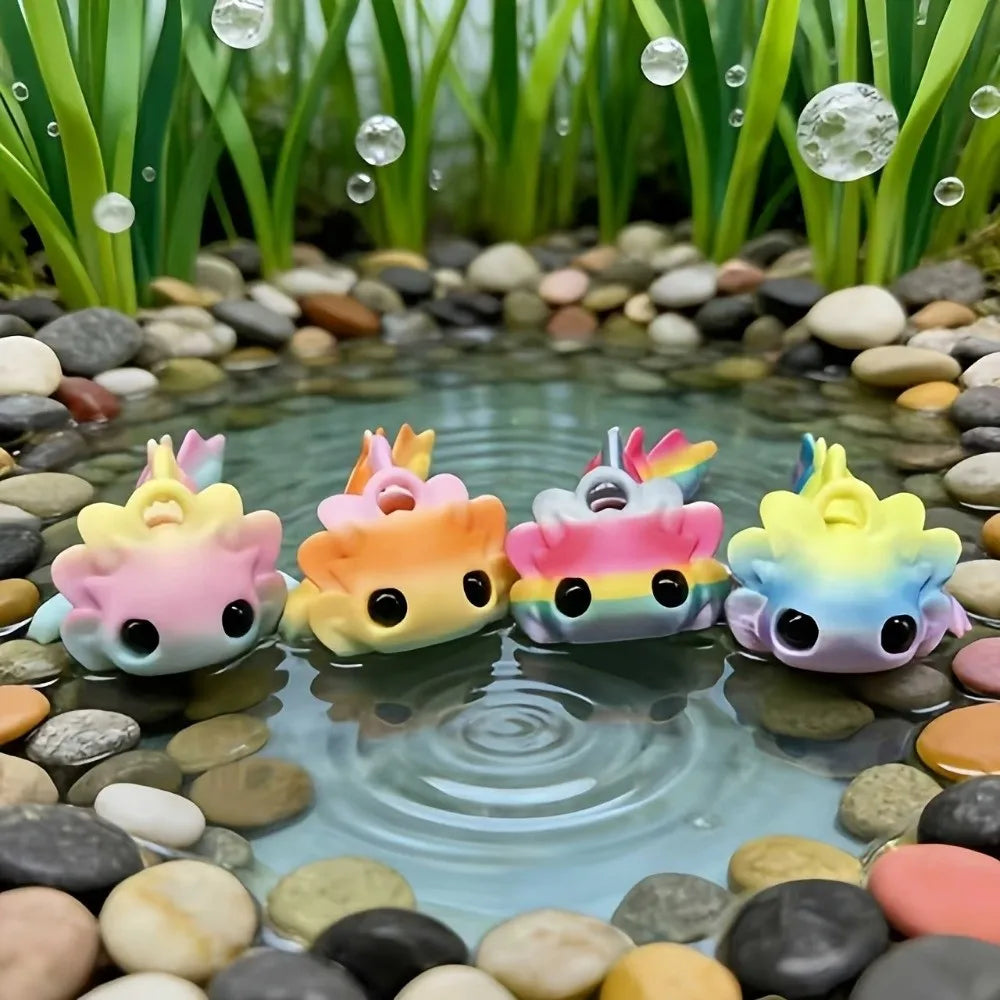 A set of eight colorful flexible salamander figurines resting in clear water surrounded by smooth stones and green aquatic pl