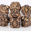 A set of seven metal dice featuring skulls and dragons in various numbers and shapes.