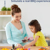 A parent and child are playing with a mini barbecue pretend play set featuring various food items like sausages and vegetable