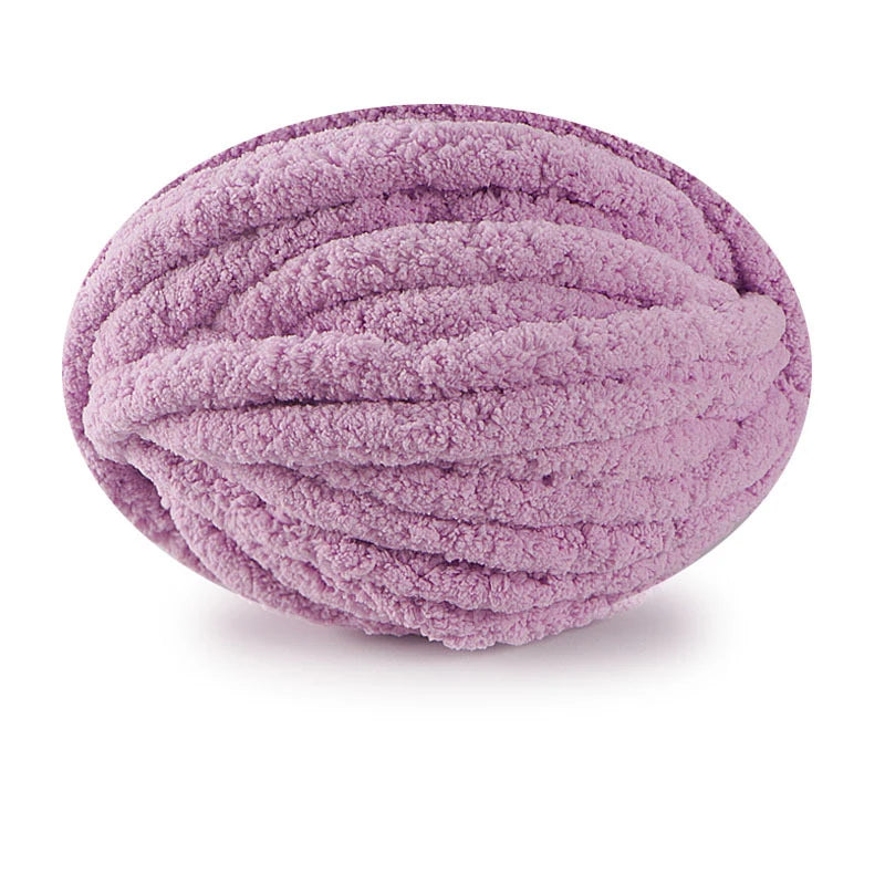 A ball of soft, purple chunky chenille yarn for hand knitting projects.