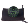 A black storage bag holds a 100-sided polyhedral die with green numbered faces.