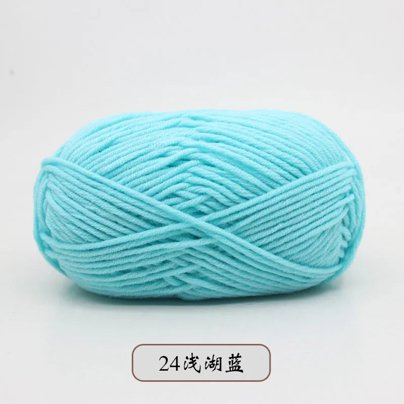 A ball of light blue pre-dyed milk cotton yarn used for knitting and crochet.