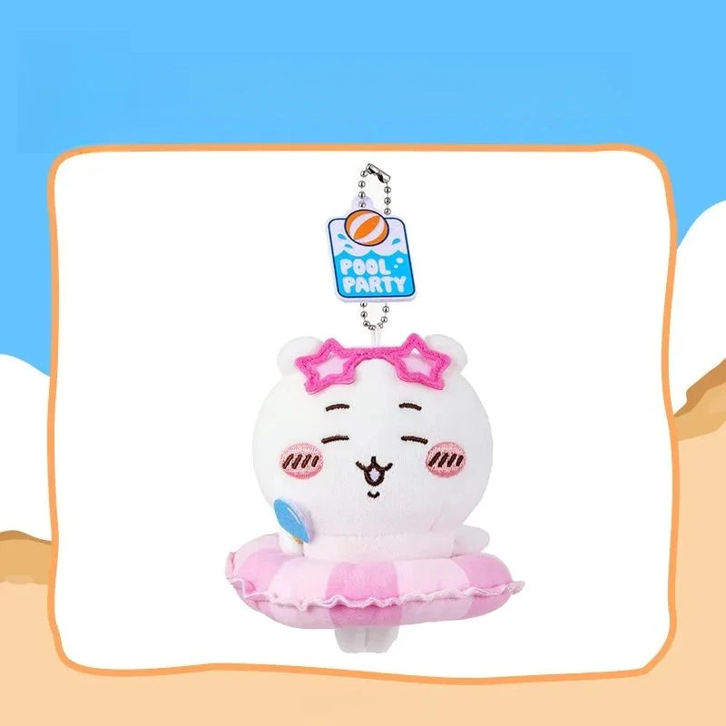 A white plush keychain charm of a smiling character with pink accents and a pink swimming ring.