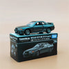 A Tomica Nissan Skyline GT-R model car in dark green is displayed on its packaging box.