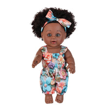 A 12-inch realistic African American baby doll with dark curly hair wearing a floral patterned outfit.