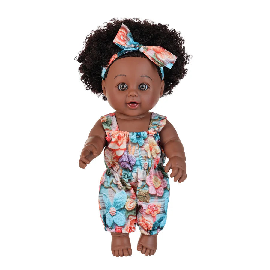 A 12-inch realistic African American baby doll with dark curly hair wearing a floral patterned outfit.