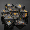 A set of seven polyhedral liquid core resin dice, including d4, d8, d10, d12, d20, and d100, displayed on a dark surface.