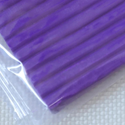 A purple silicone modeling clay tool is shown against a white background.
