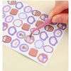 A hand uses a pink precision stainless steel tweezer to pick up a piece of food from a patterned paper.