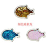 A silver-colored fish-shaped charm covered in gold glitter and a pink fish-shaped charm covered in pink glitter.