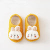 Pair of yellow plush baby slippers shaped like rabbits with white inner lining