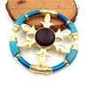 A metal fidget spinner featuring a gold-colored cross design with blue iridescent finish.
