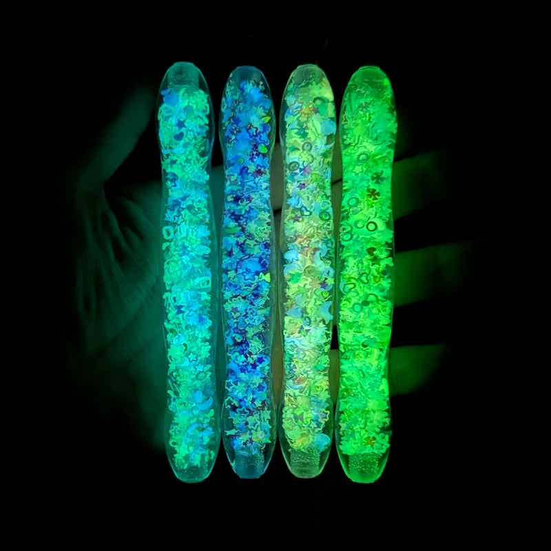 Six glow-in-the-dark diamond painting pens with interchangeable tips showing vibrant blue and green colors.