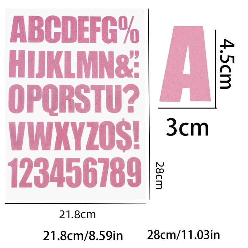 A sheet of pink DIY iron-on heat transfer patches showing an alphabet and numbers for crafting