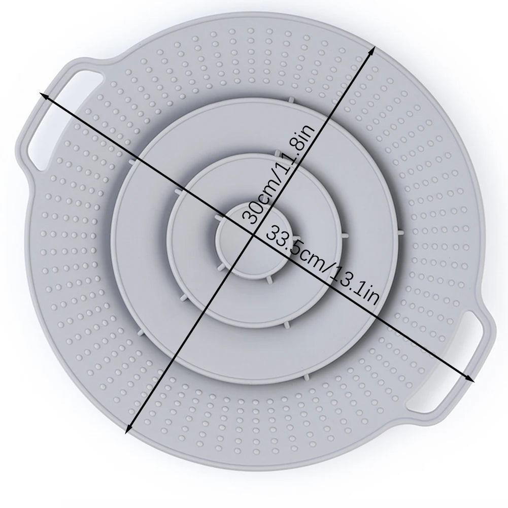 A gray silicone spill stopper lid with measurement markings for pots and pans.
