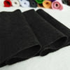 A stack of black felt fabric sheets for DIY crafts and sewing projects.